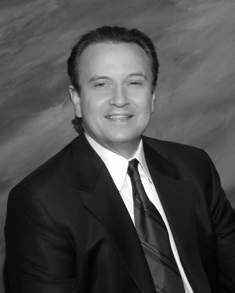 Dr. J. Jerome Smith, in a dark suit and tie, black and white portrait.